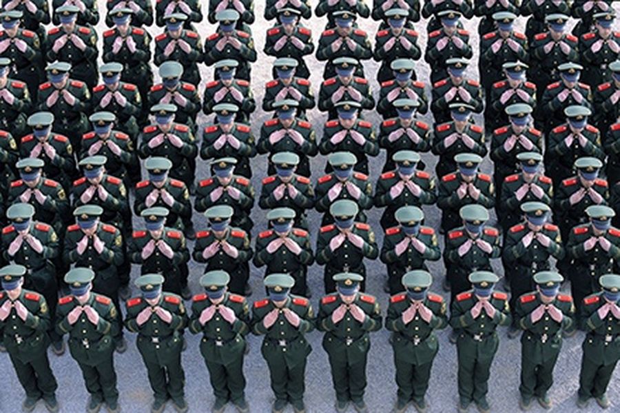 Recruits of the paramilitary police adjust their uniforms during a training session at a military base in Taiyuan, Shanxi province.