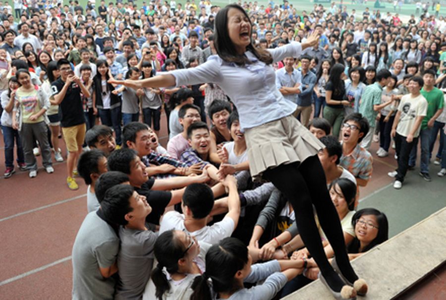A teacher falls backwards during a pressure releasing exercise at a high school in Chongqing