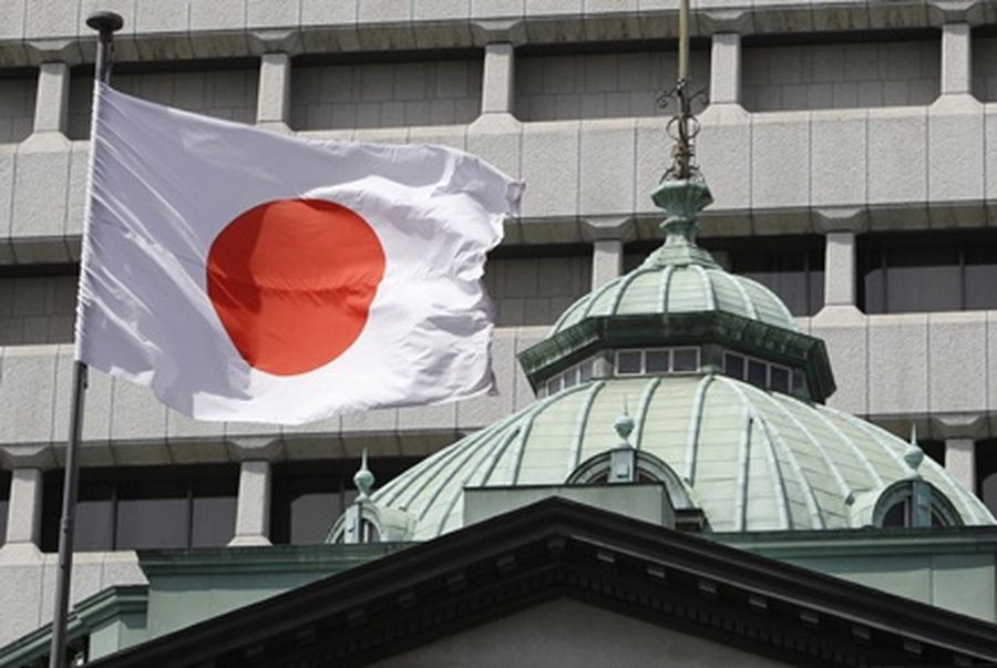 A Japanese flag flutters atop the Bank of Japan building in Tokyo. 