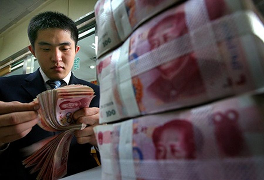 A Chinese bank employee counts yuan notes at a local bank in Nanjing, capital of east China’s Jiangsu.