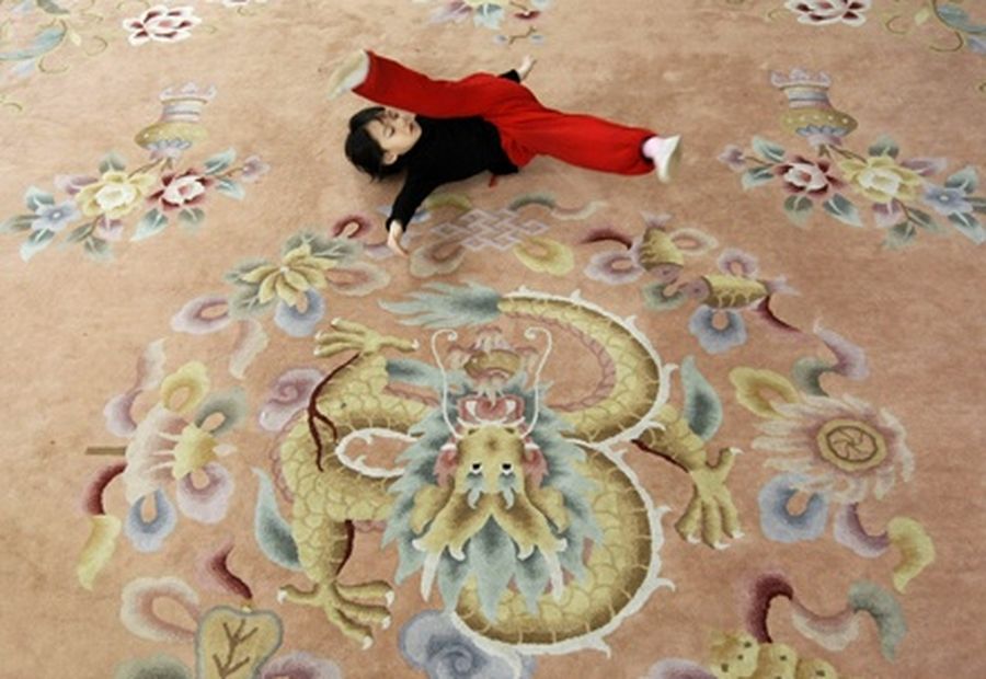 A five-year-old girl performs some basic skills during a training session at a Peking opera art school in Beijing. 