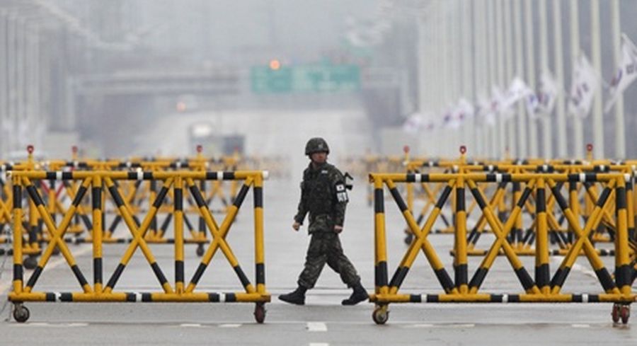 A South Korean soldier patrols as vehicles returning from North Korea's inter-Korean Kaesong Industrial Complex back to South Korea arrive at a checkpoint on the Grand Unification Bridge.