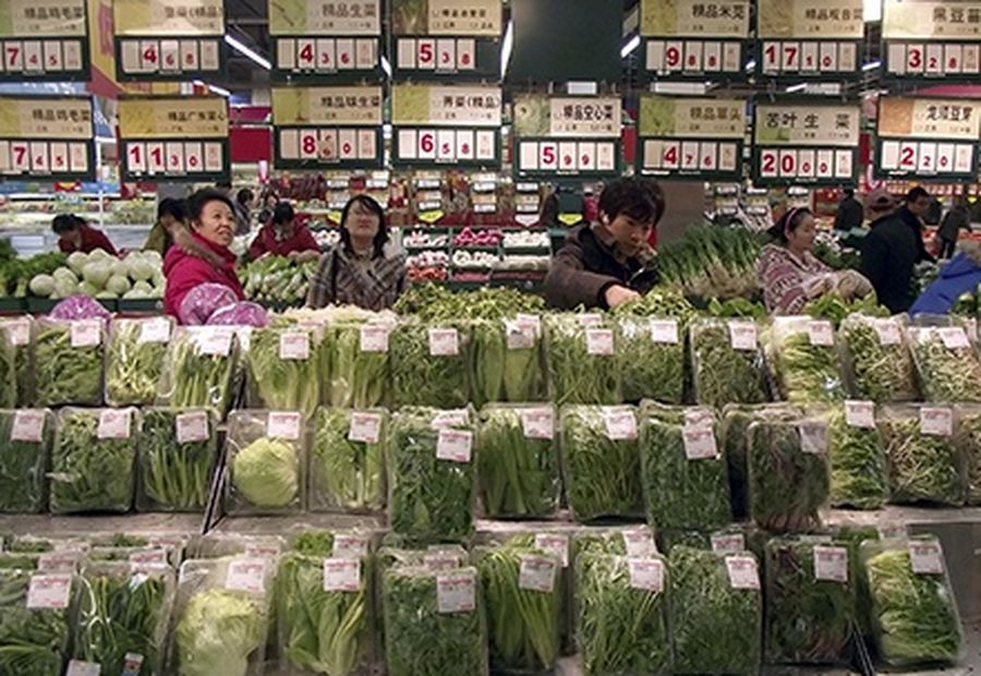 Customers select vegetables at a supermarket in Changzhou, Jiangsu province.