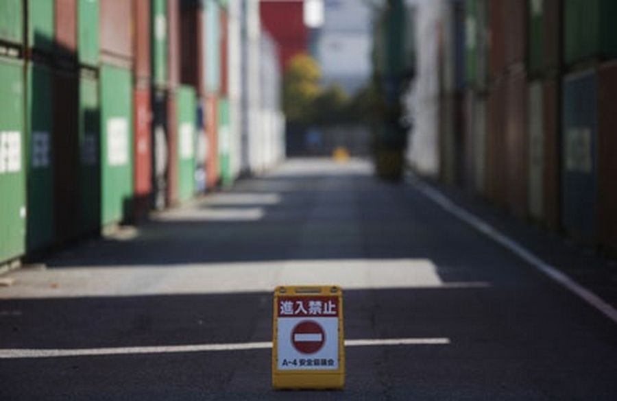 A 'no entry' sign is seen near containers at a port in Tokyo.
