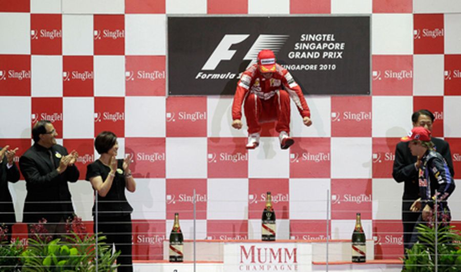 Ferrari Formula One driver Fernando Alonso of Spain celebrates on the podium after winning the Singa