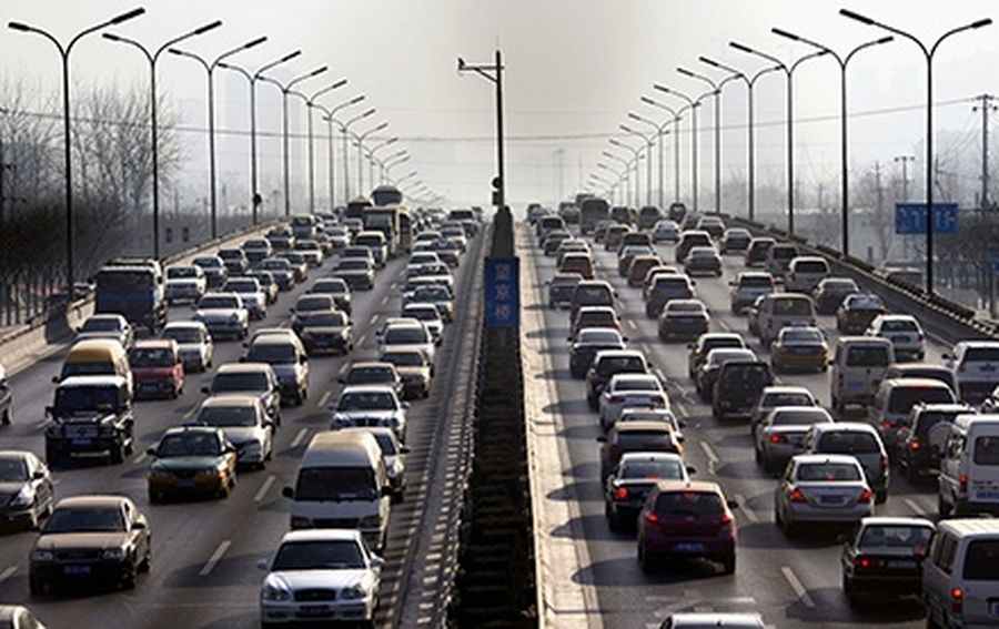 Cars drive along a main road in central Beijing.