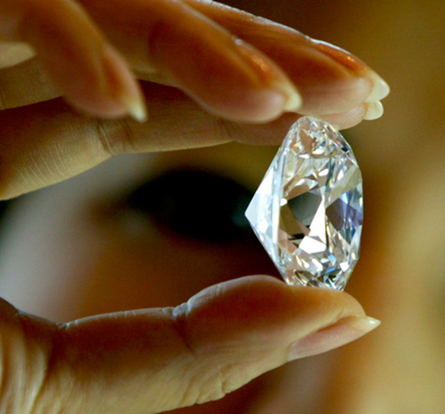 An employee holds the largest D colour internally flawless diamond for auction offered by Sotheby's 