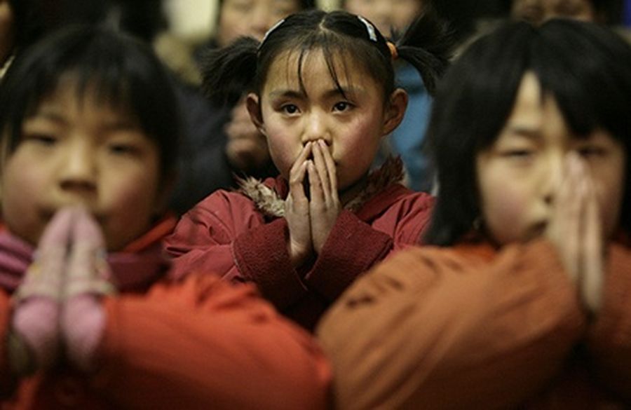 Girls attend a mass at a Catholic church in a village at the outskirts of Taiyuan, Shanxi province.