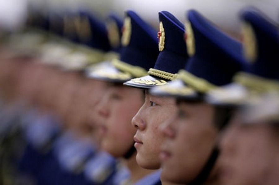 Honour guards stand in a line before an official welcoming ceremony inside the Great Hall of the People in Beijing.