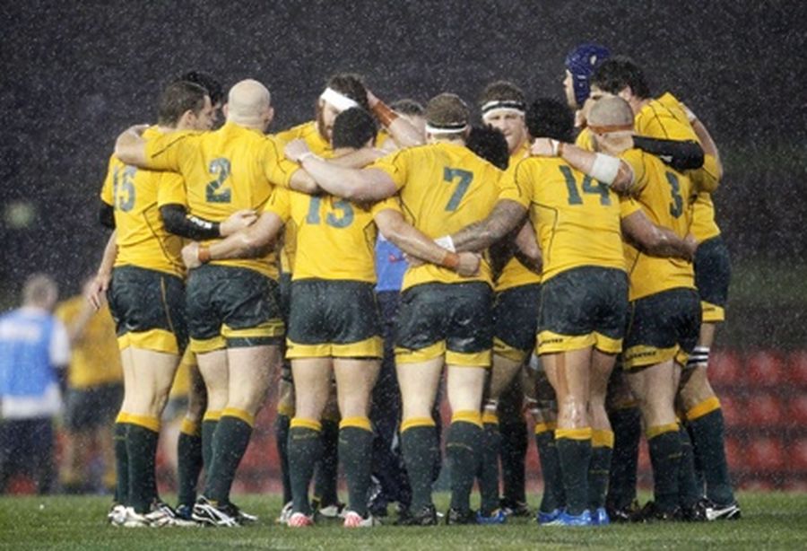 Australian players wait for an umpire’s decision during an international rugby union test match.