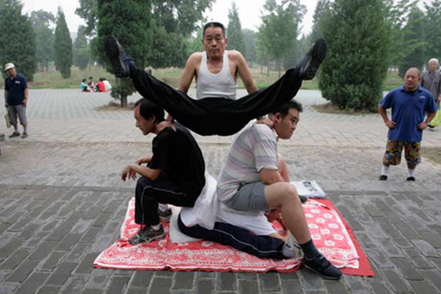 Gao Mingyuan, 66, stretches himself with a team of Chinese martial arts fans during a morning exerci