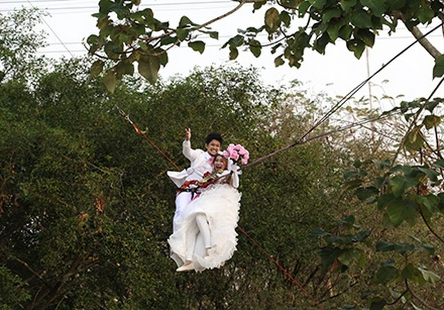Thai groom Prasit Rangsiyawong (L), 29, and his bride Varuttaon Rangsiyawong, 27, fly while attached to cables during a wedding ceremony ahead of Valentine’s Day in Prachin Buri province, east of Bangkok.