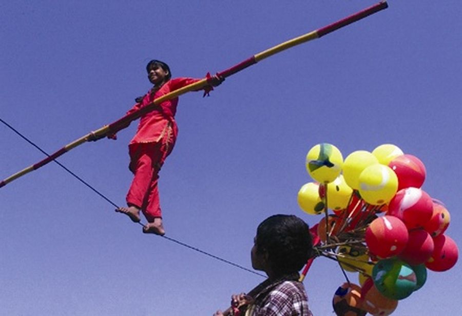An Indian girl walks on a rope during the Festival of Gardens in northern city of Chandigarh.