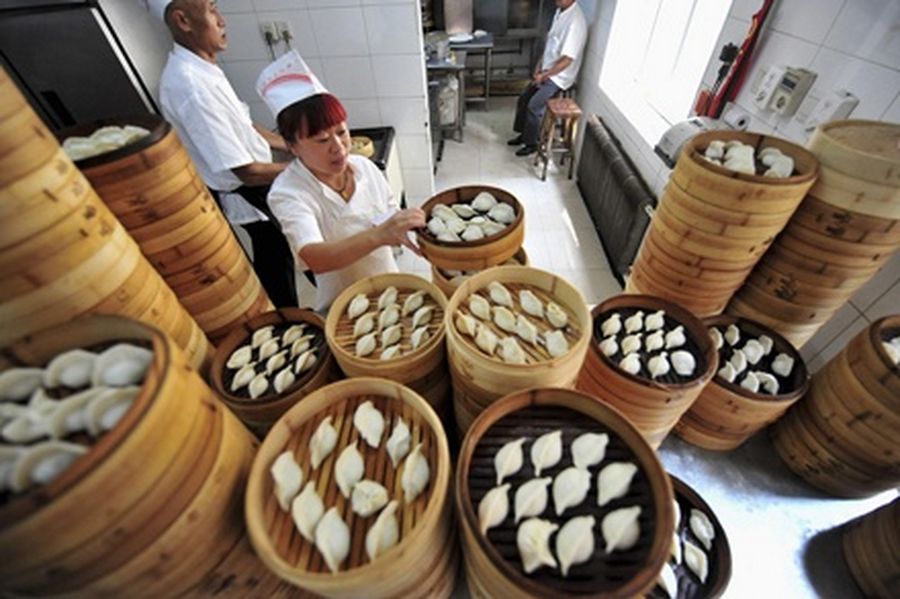 A cook arranges baskets of newly made dumplings at a restaurant in Shenyang.