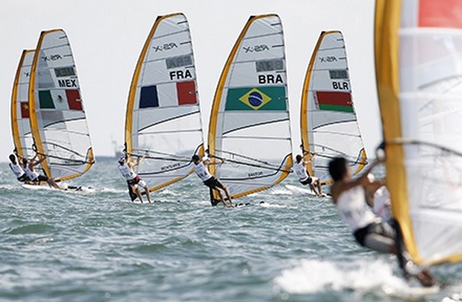 Surfers competing in the RS:X men’s windsurfing class sail upwind during the second race of the sailing competition in Beijing.