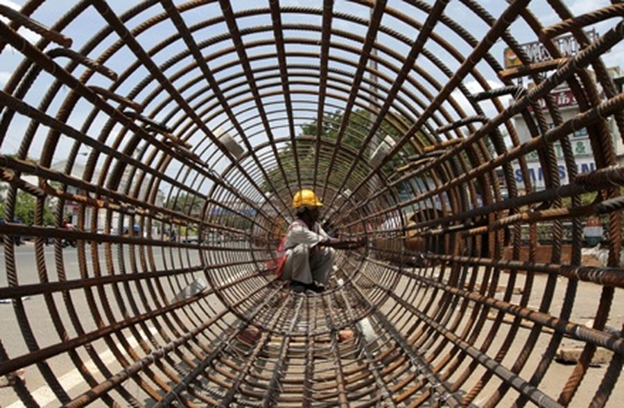 A worker wires steel rebars at a construction site of a metro station in the southern Indian city of Chennai. 
