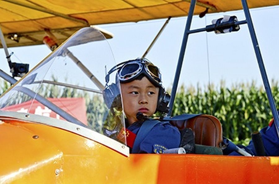 He Yide sits in a glider before flying a plane in Guan county, Hebei province. He, 5, piloted a plane, accompanied by his coach. The flight from Guan county to Beijing Wildlife Park at 150m high took around 35 minutes and landed successfully.