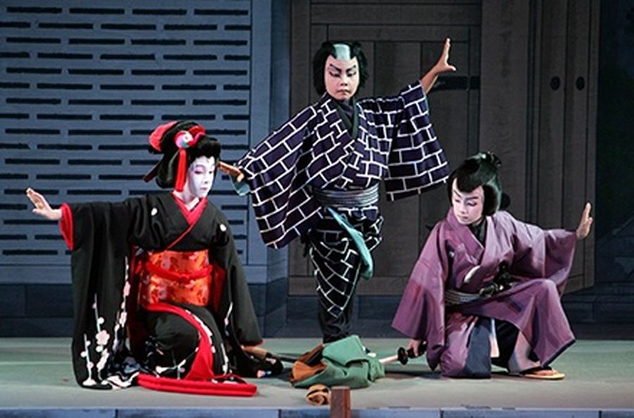 A boy (L) plays a woman’s role, “Onnagata”, with other boys during their Kabuki performance on stage at Edo Tokyo Museum in Tokyo.